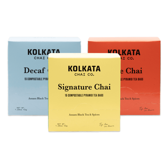 Three boxes of Kolkata Chai Co. tea bags in different colors on a black background.