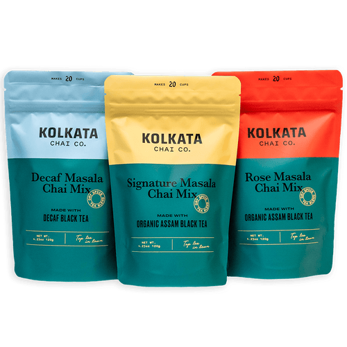 Three colorful pouches of Kolkata Chai Co. organic Assam black tea blends.